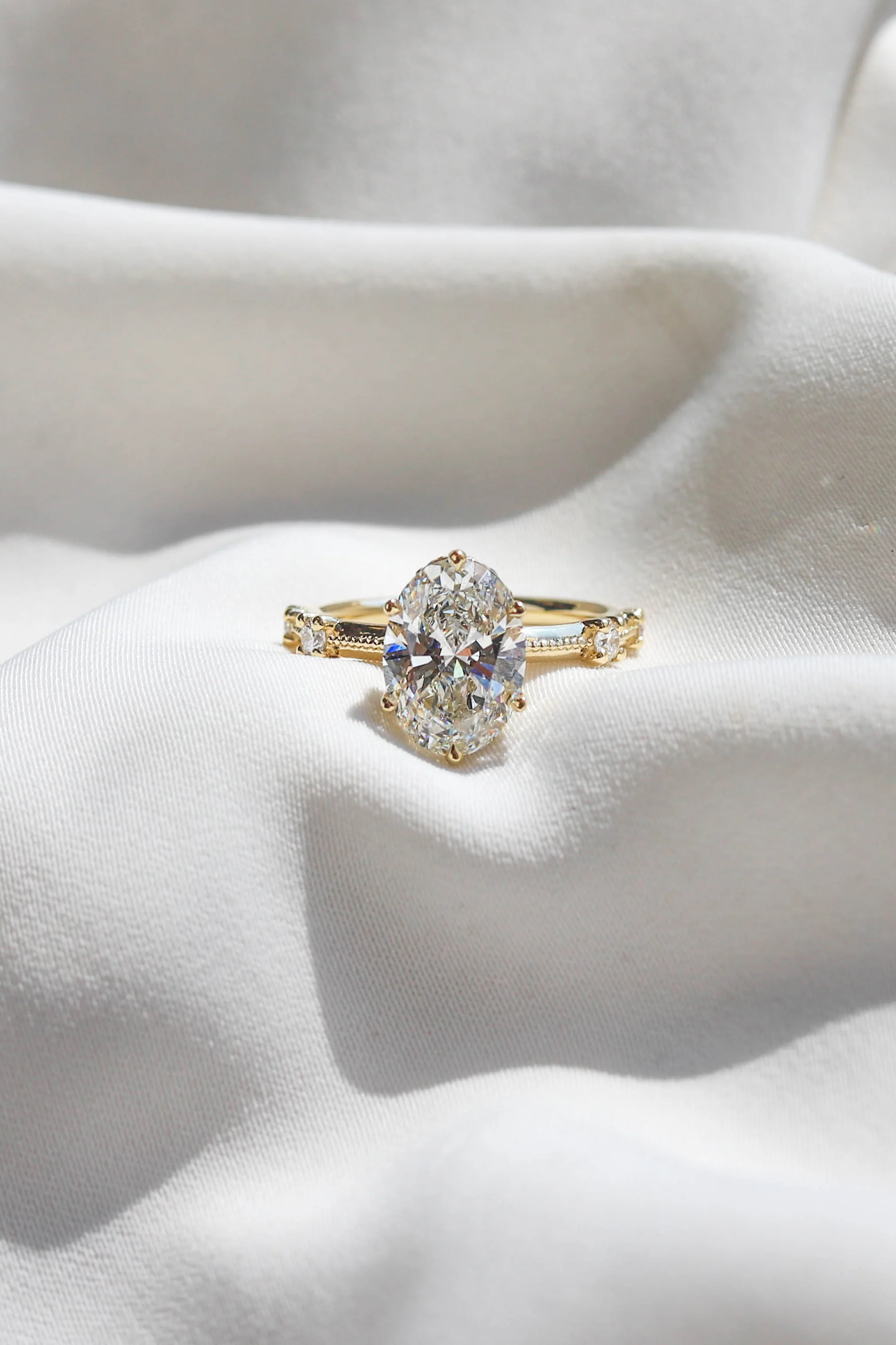 3.00ct lab-grown oval-cut diamond engagement ring set in warm yellow gold by Beaudell Diamonds