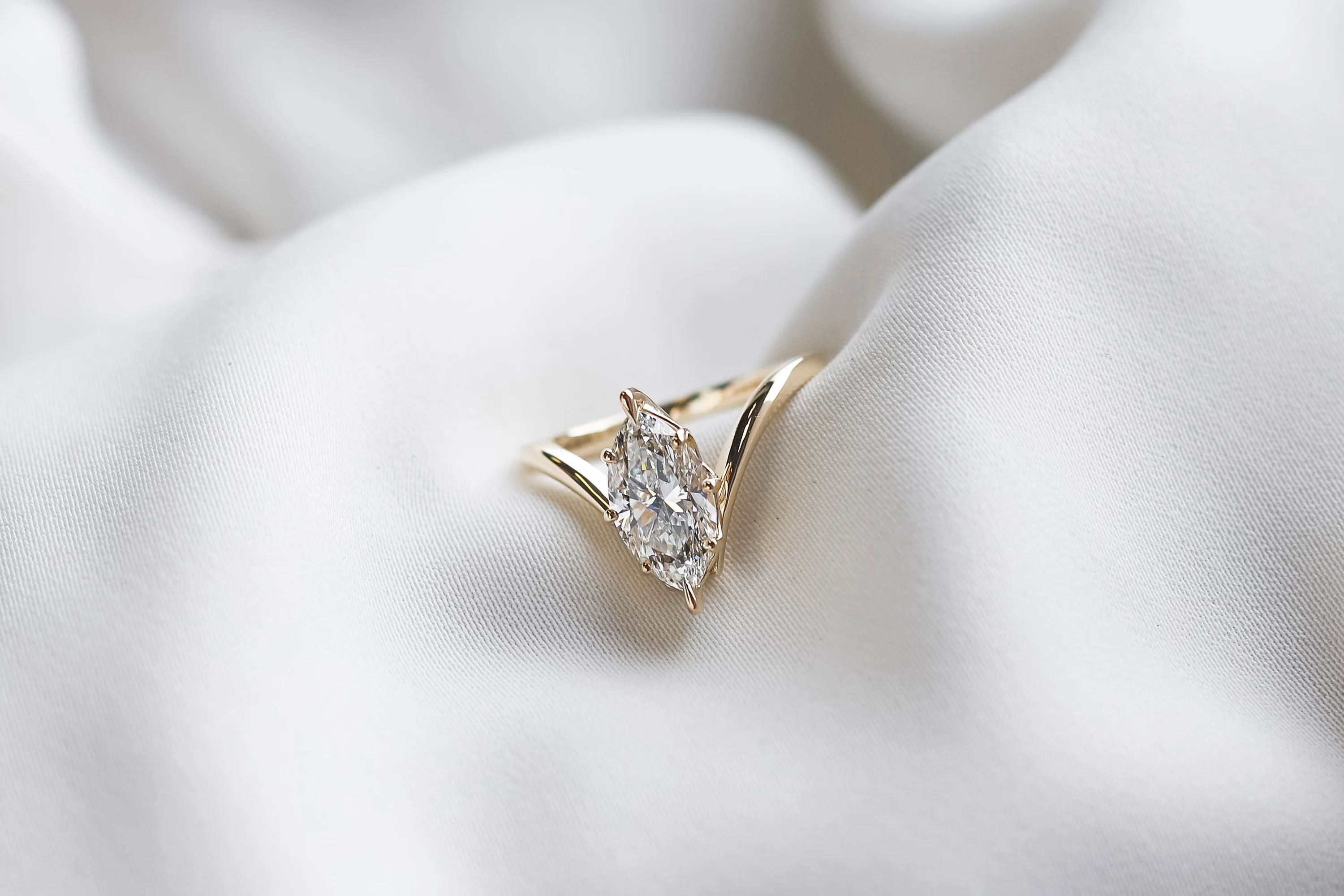 2.00ct lab-grown marquise-cut diamond engagement ring set in a V-shaped yellow gold setting by Beaudell Diamonds