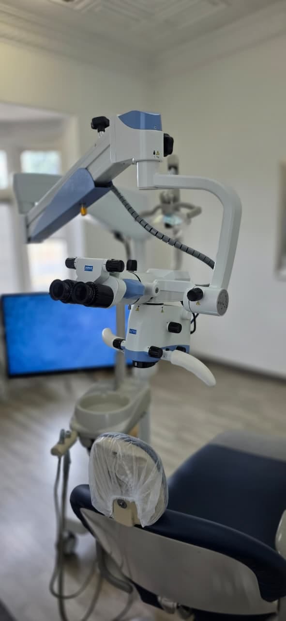 High-precision dental surgical operating microscope over patient chair
