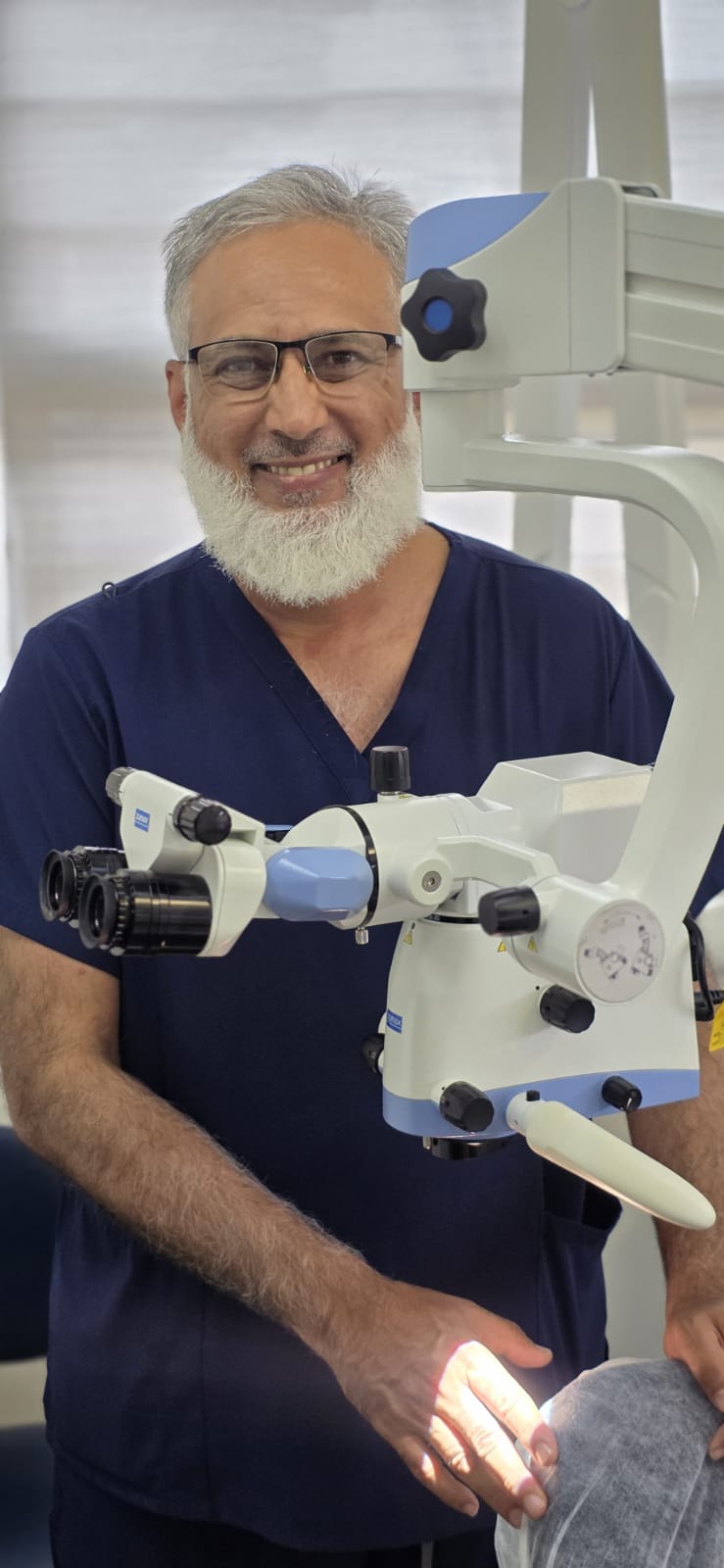 Dr Mohammed Khan Patel with the dental surgical operating microscope