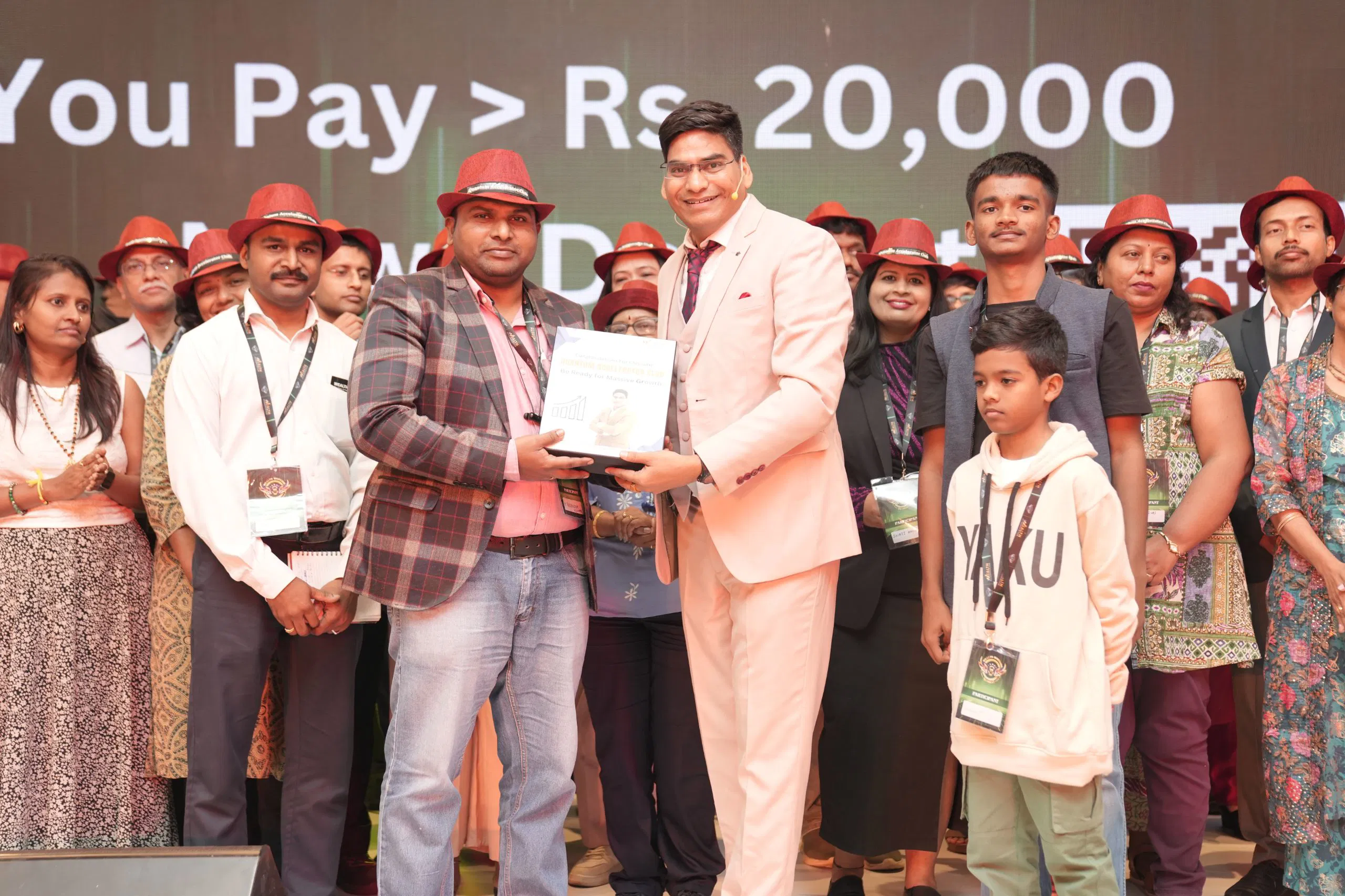 Stage recognition ceremony with mentors and authors at Wealth Warrior Retreat July 2025