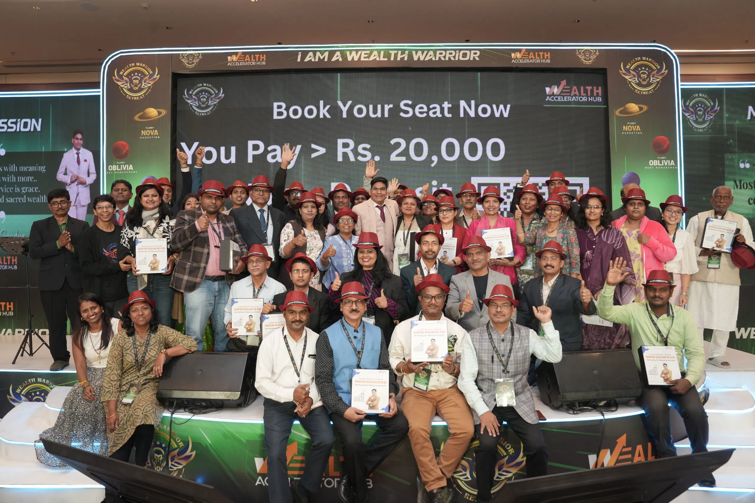Wealth Warrior Retreat grand stage group photograph with participants, mentors and authors at Wealth Accelerator Hub