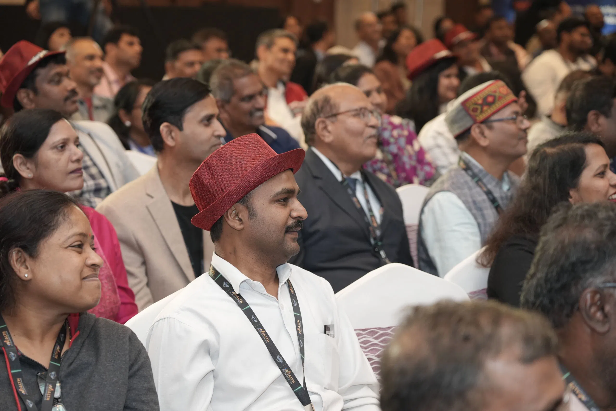 Thandavarayan M. wearing red hat in keynote audience at Wealth Warrior Retreat