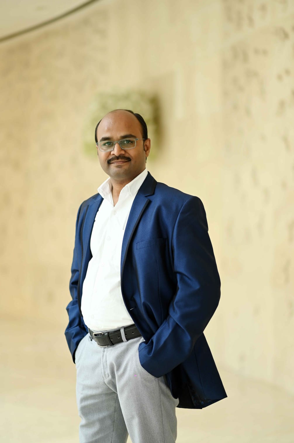 Professional portrait of Thandavarayan M. in blue blazer