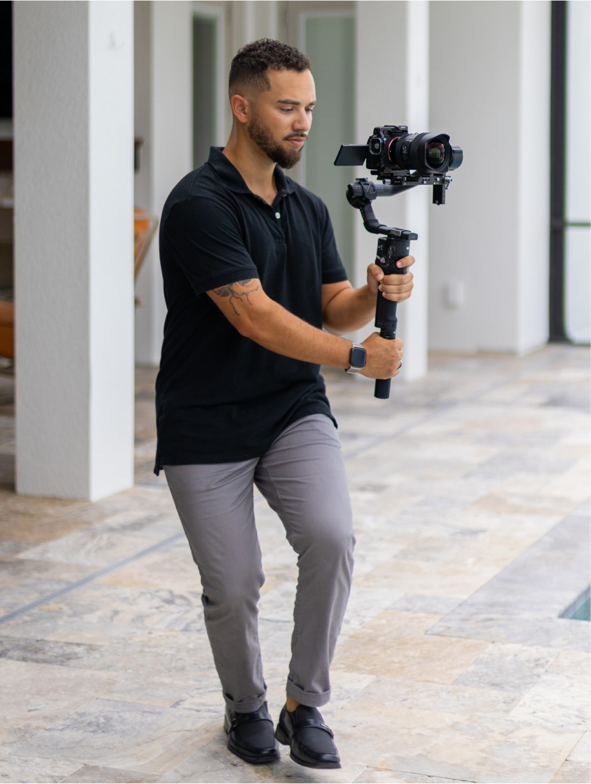 StudioCLI videographer with gimbal camera on location
