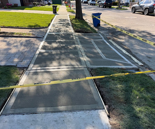 Freshly finished residential concrete sidewalk along street curb