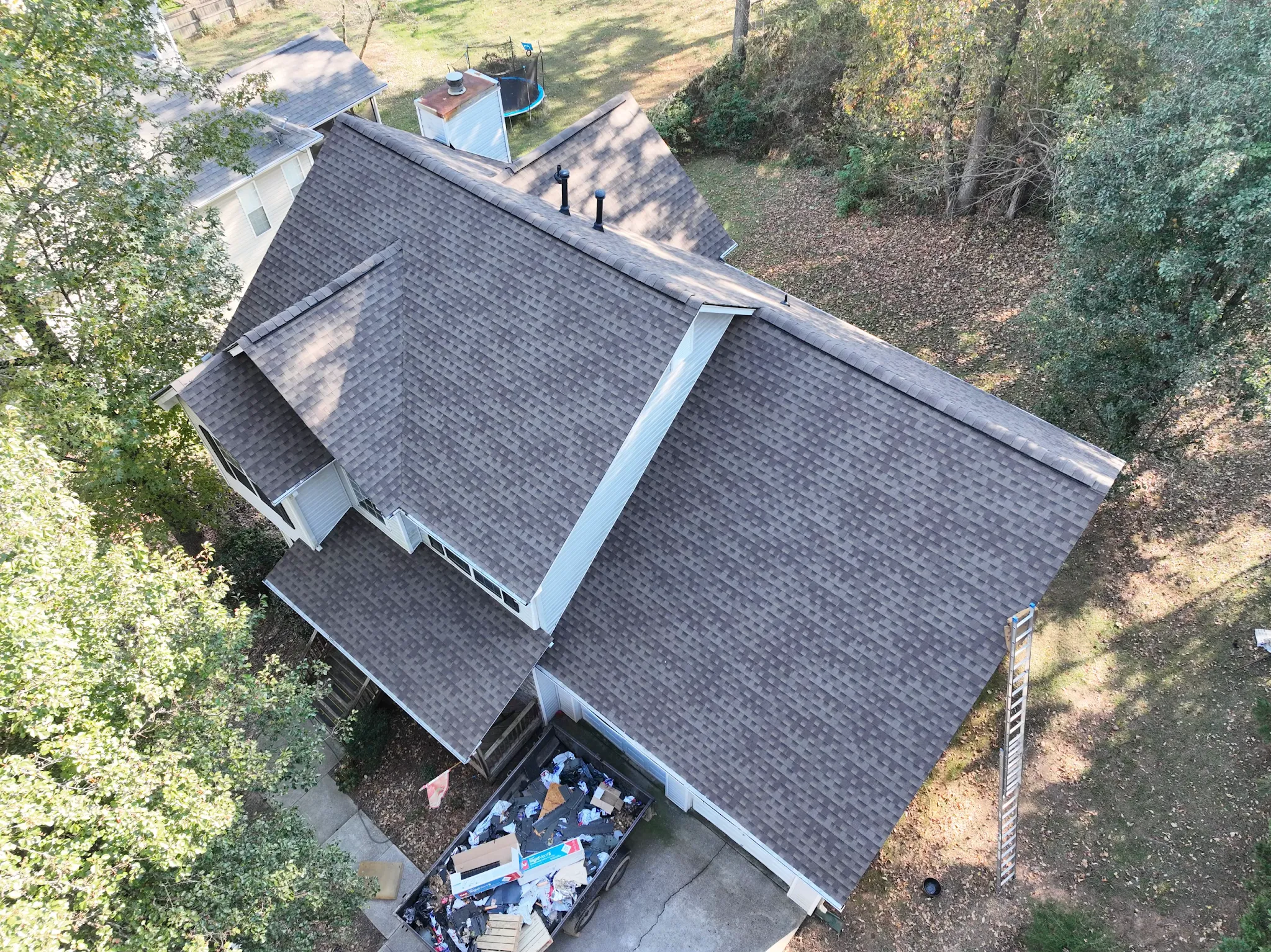 Aerial view of Randy Williams' completed roof replacement with architectural shingles and organized jobsite
