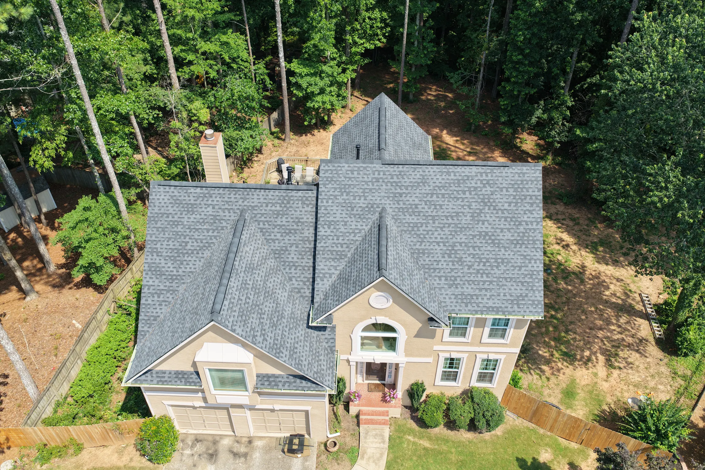 High-resolution aerial drone photograph of completed architectural roof replacement for Nicole Geer's home by Apex Roofing Solutions