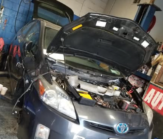 Toyota Prius undergoing mechanical repair at First Class Auto Repairs in Copiague, NY