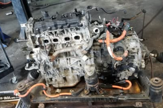 Toyota Prius engine and hybrid drivetrain assembly on workbench at our Copiague shop