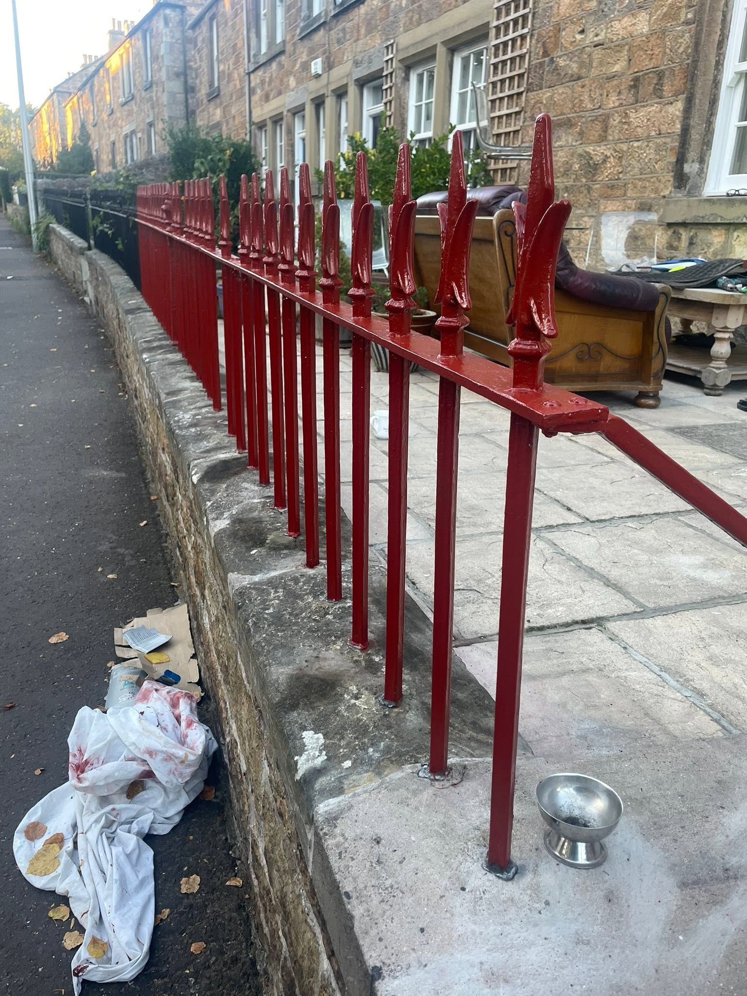 Exterior painting and restoration of traditional wrought iron boundary railings on stone wall in Dalkeith