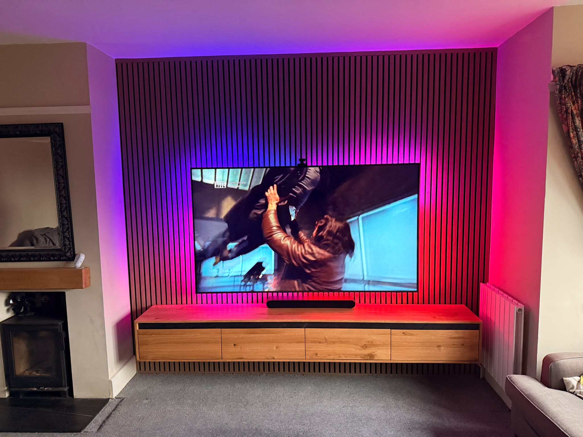 Custom slat media wall with floating oak unit — Amesbury