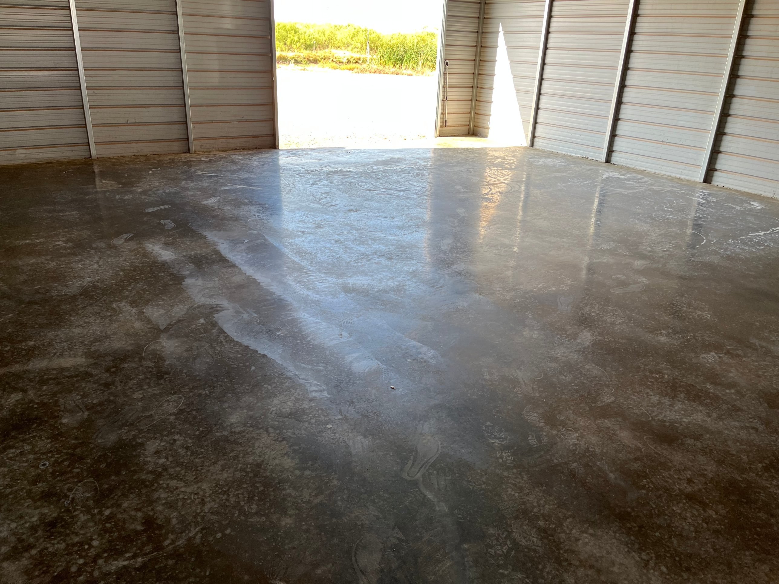 Freshly finished concrete floor inside a metal building