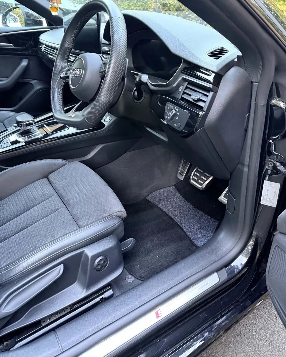 Audi A4 interior footwell after HS valeting — clean shampooed carpet and dressed trim