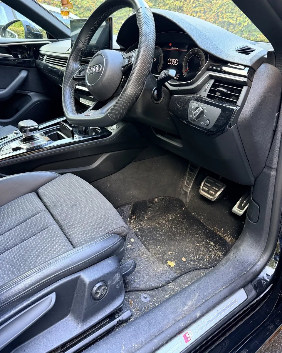 Audi A4 interior footwell before valeting — dirty carpet and pedals