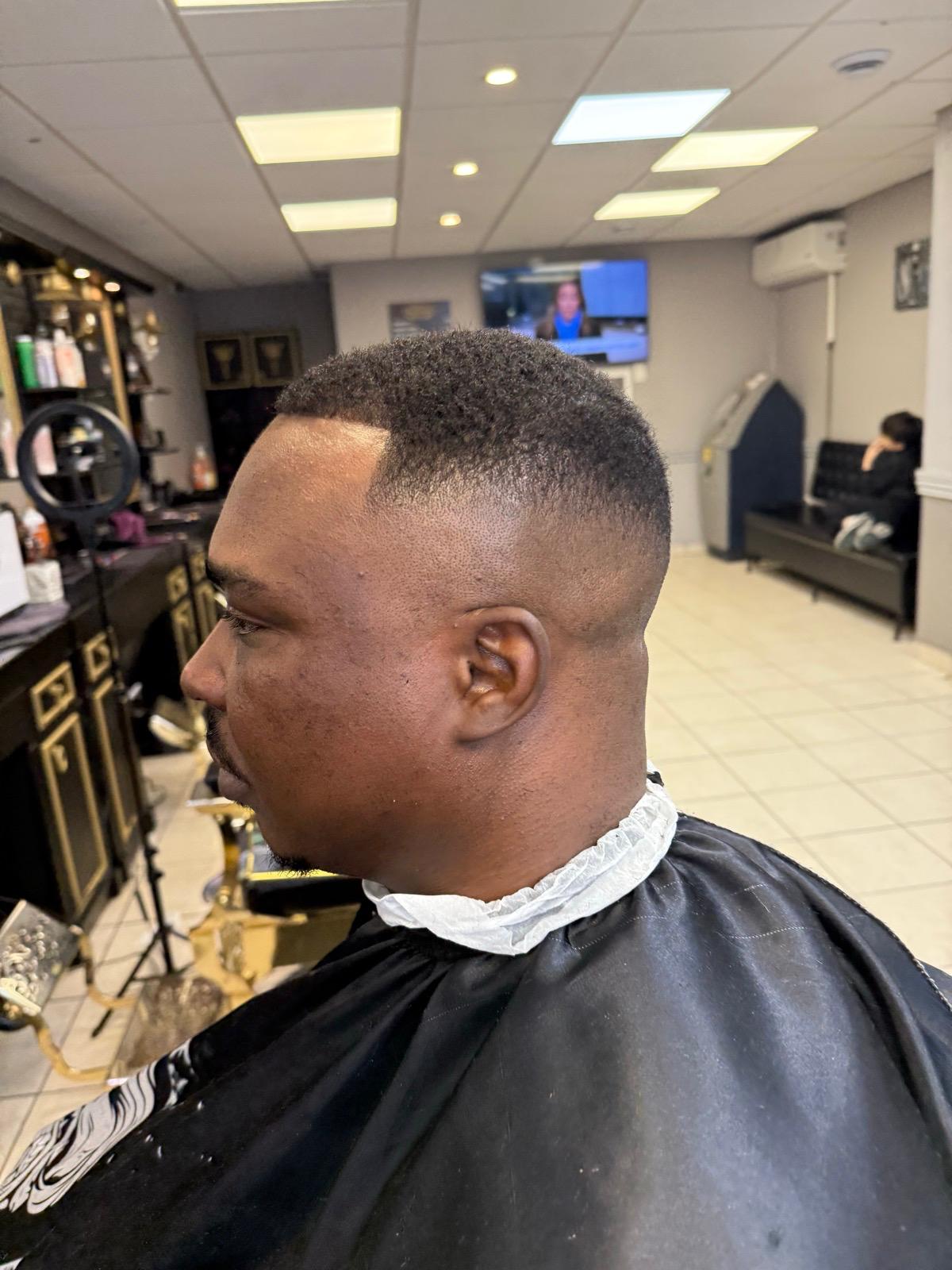 High skin fade with sharp front lineup and clean edge-up