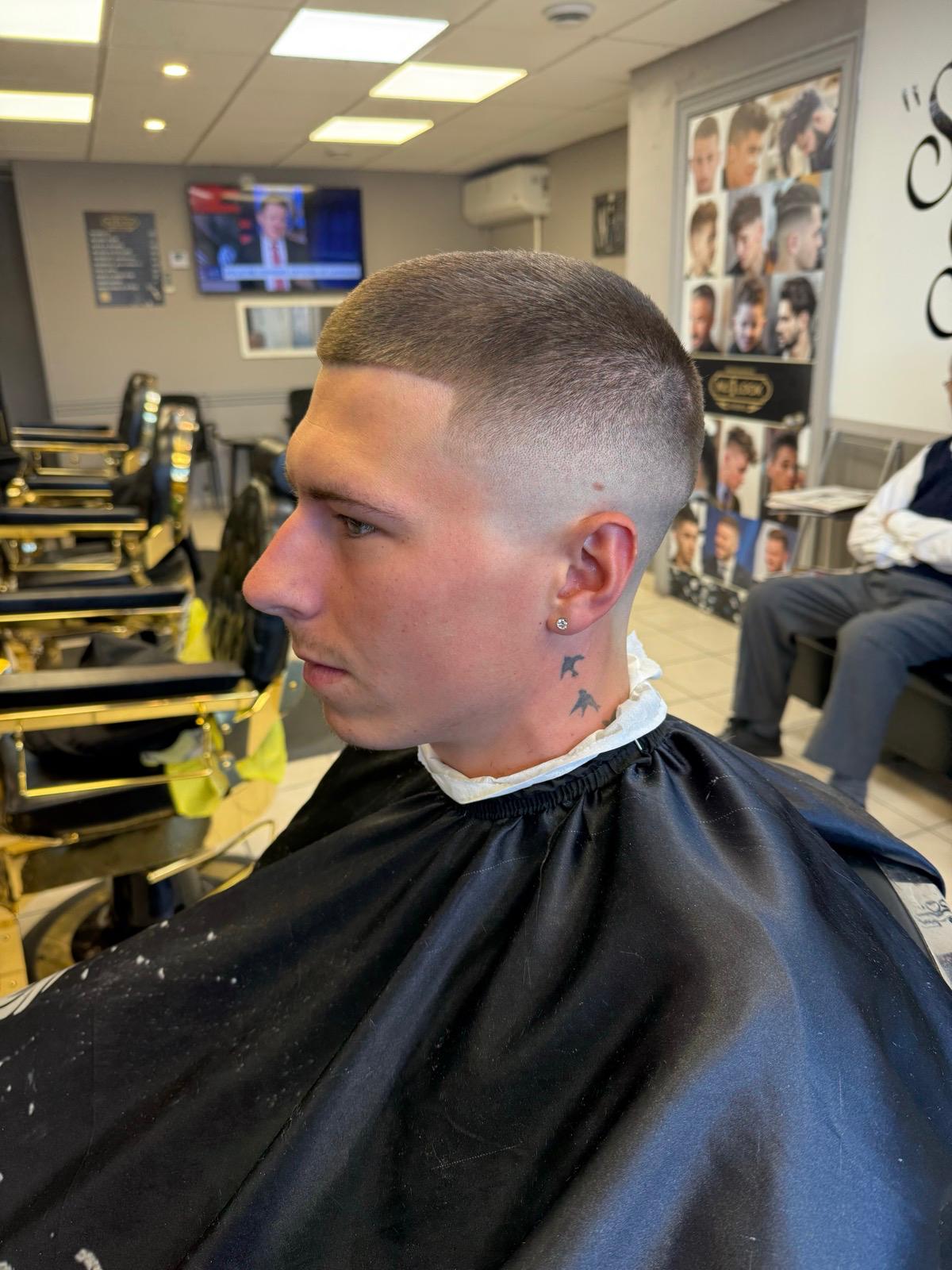 Clean buzz crop with mid skin fade and precision temple blend