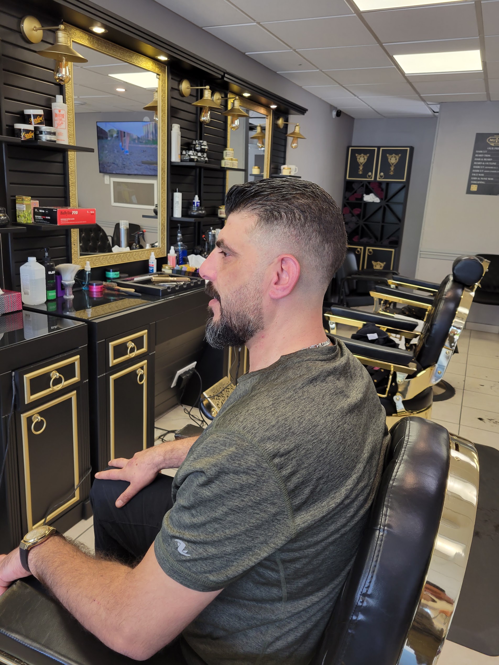 Gentlemen low fade and sculpted beard in Nu Look barber chair