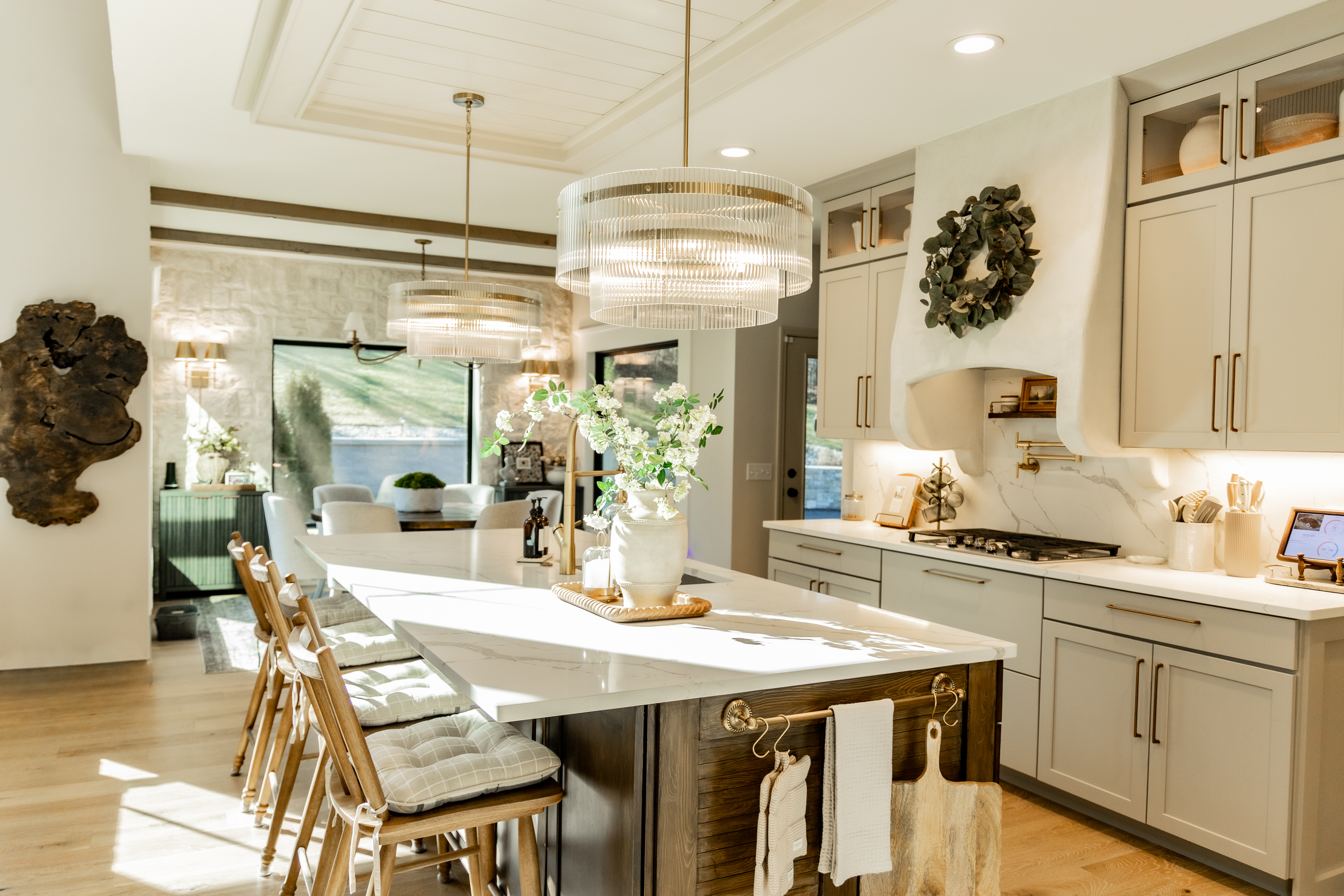 Custom architectural range hood, warm greige cabinets, and polished quartz counters in Wentzville Missouri kitchen renovation