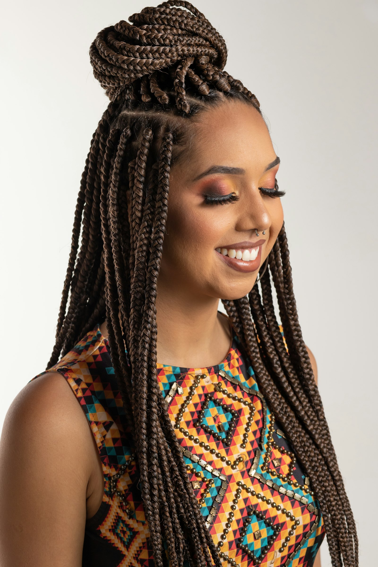 A woman with a beautifully braided protective style, showcasing versatile protective styling for all hair types at La Salon in Pickering