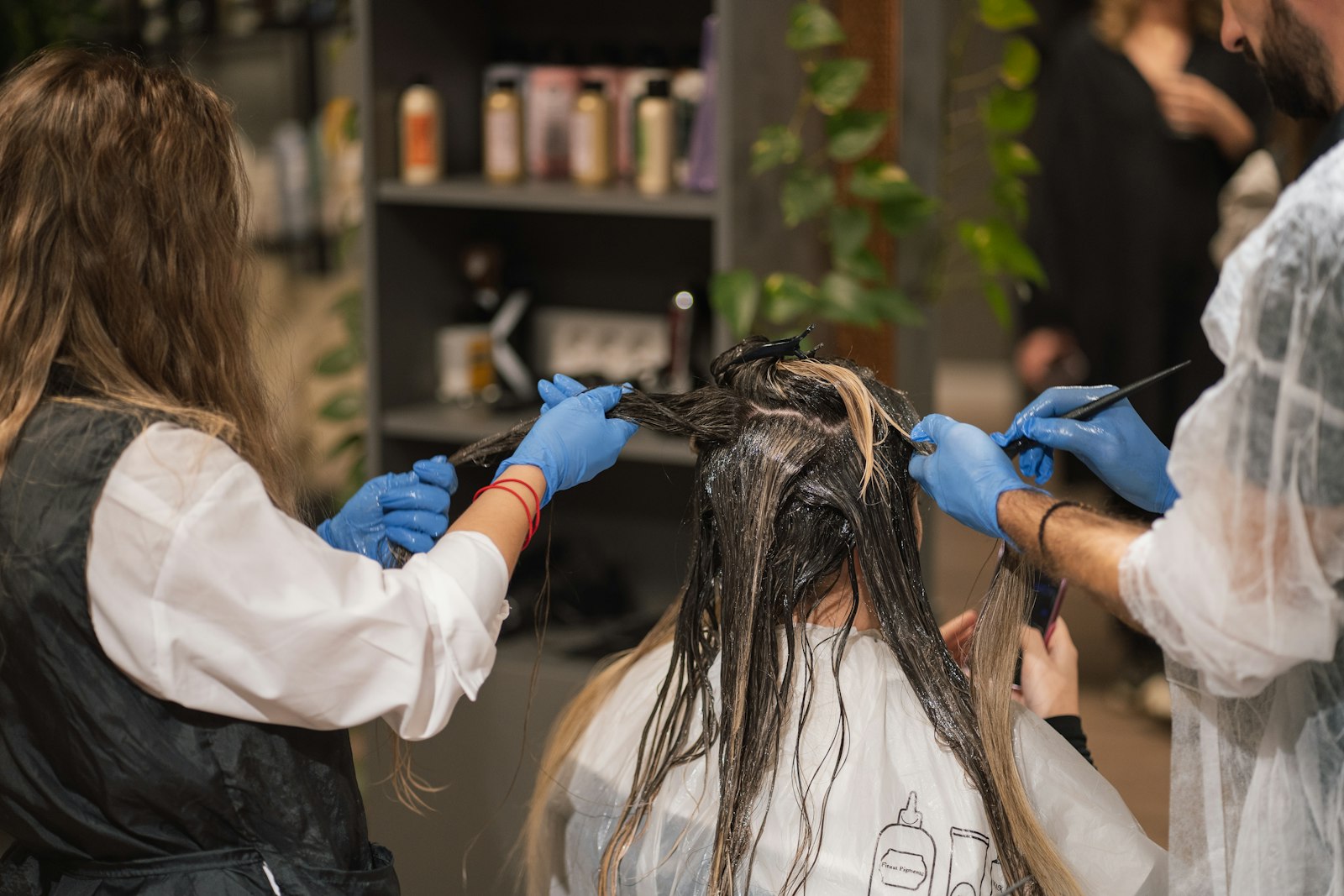 A woman relaxing in a salon chair while a stylist tends to her natural hair, reflecting the welcoming first-visit experience at La Salon in Pickering