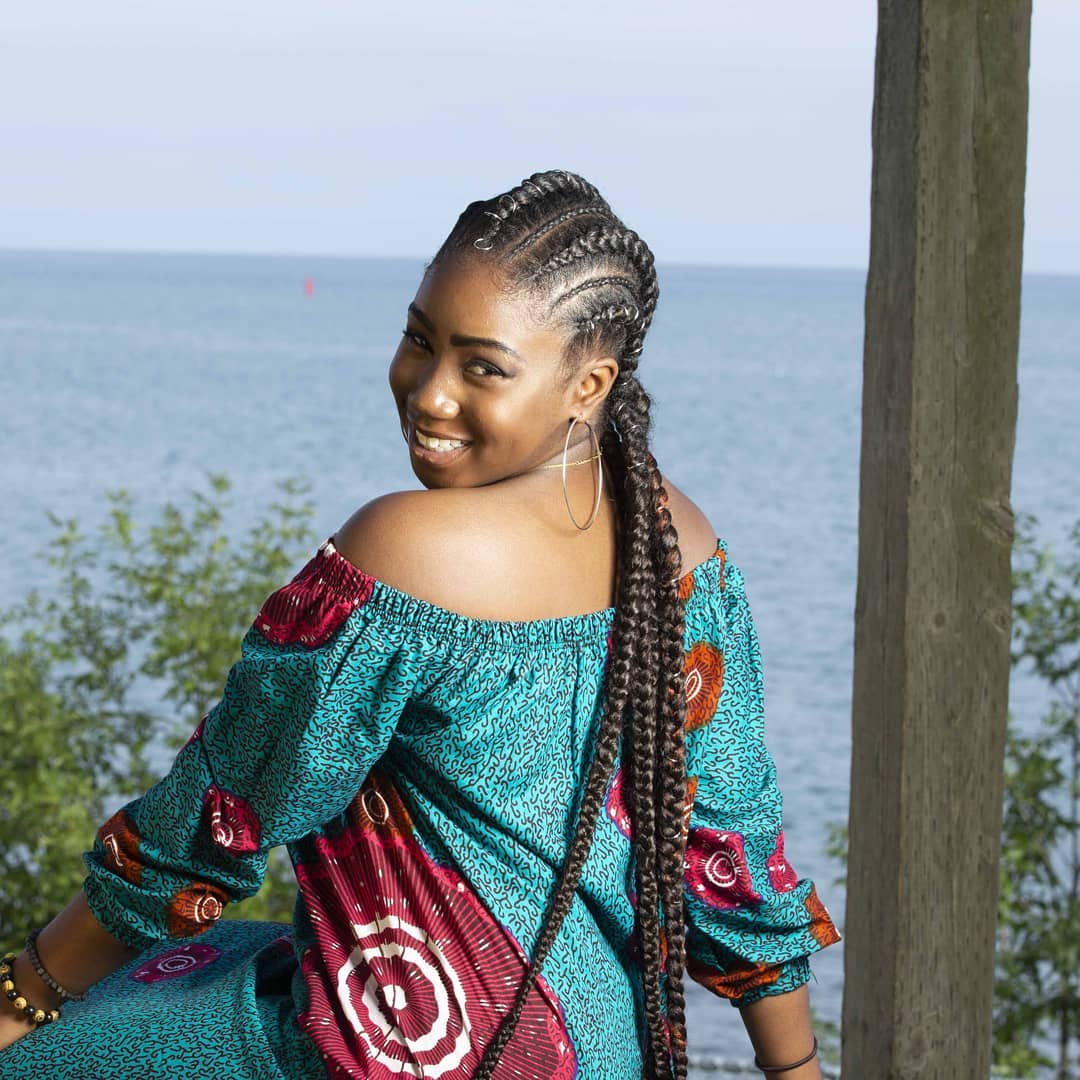 Clean stitch cornrows into long dual braided tails with metallic hair jewellery in Pickering, Ontario