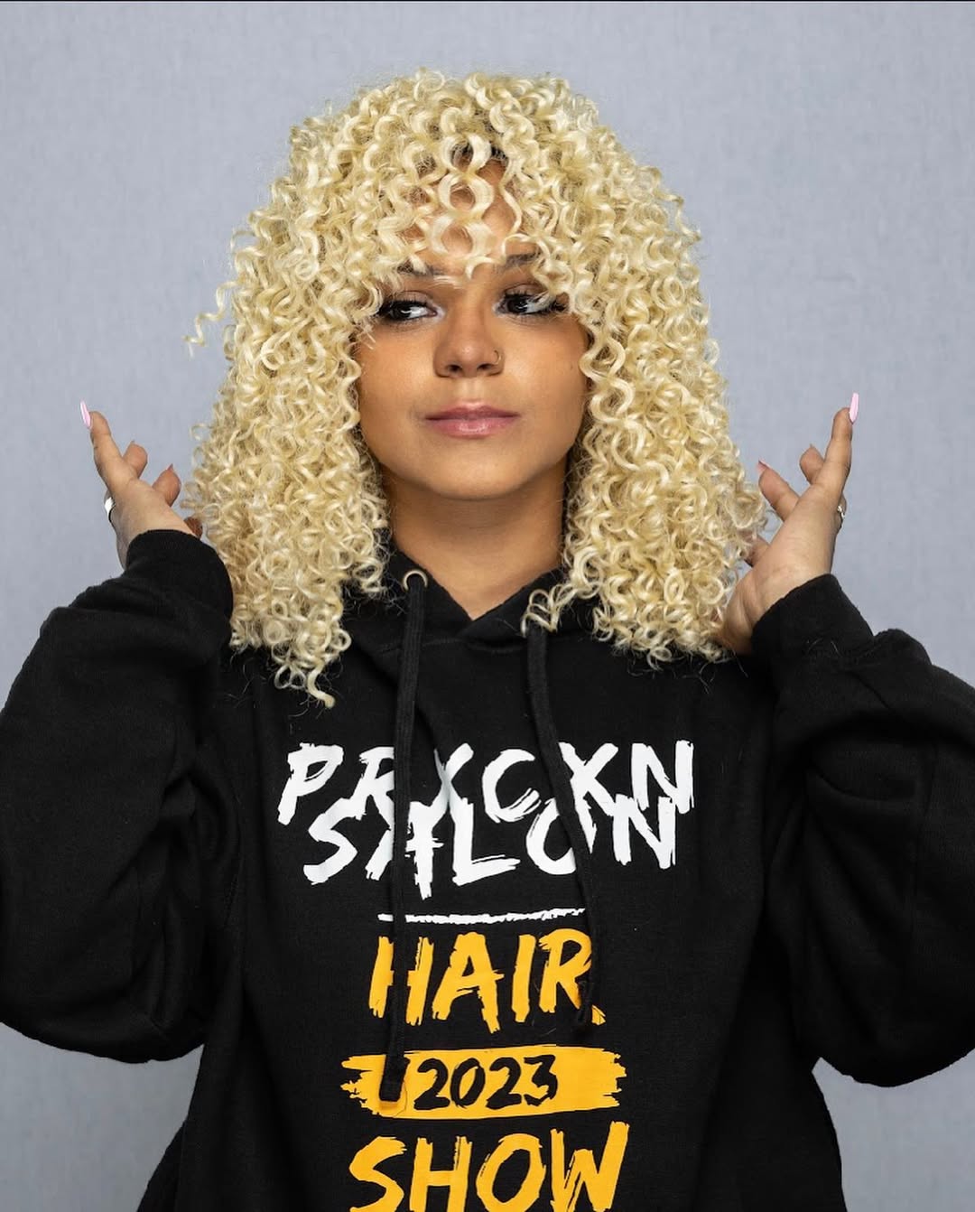 Platinum blonde spiral curls with fringe styled by Precious Reeves at La Salon in Pickering, Ontario