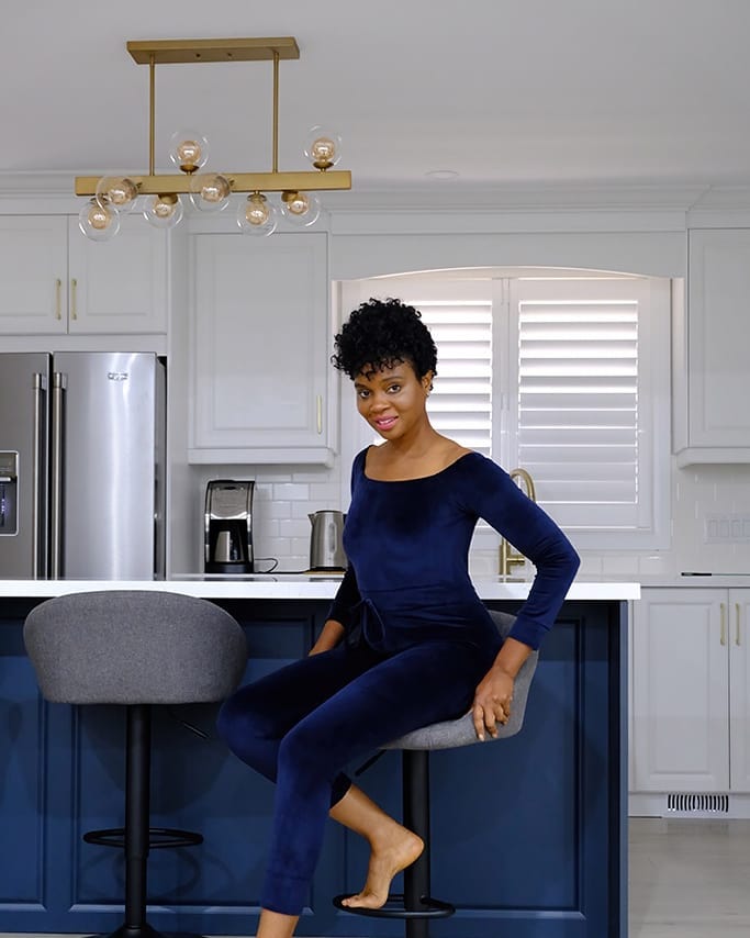 Precious Reeves seated in navy loungewear showcasing cropped natural curls at La Salon
