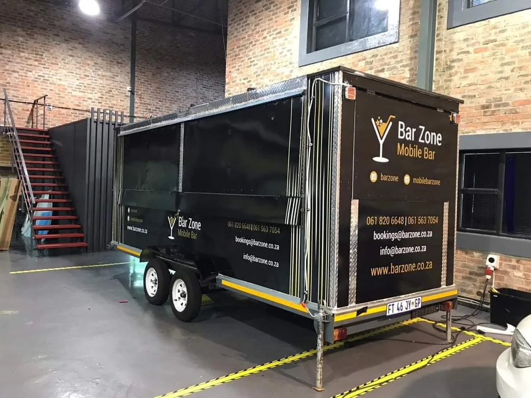Rear and side view of the black Bar Zone mobile bar trailer