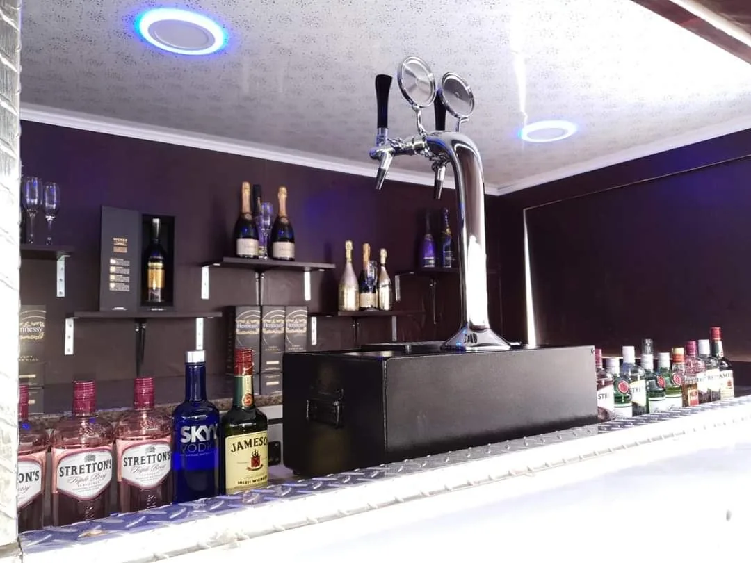Draught beer tap and drinks shelving inside the Bar Zone trailer