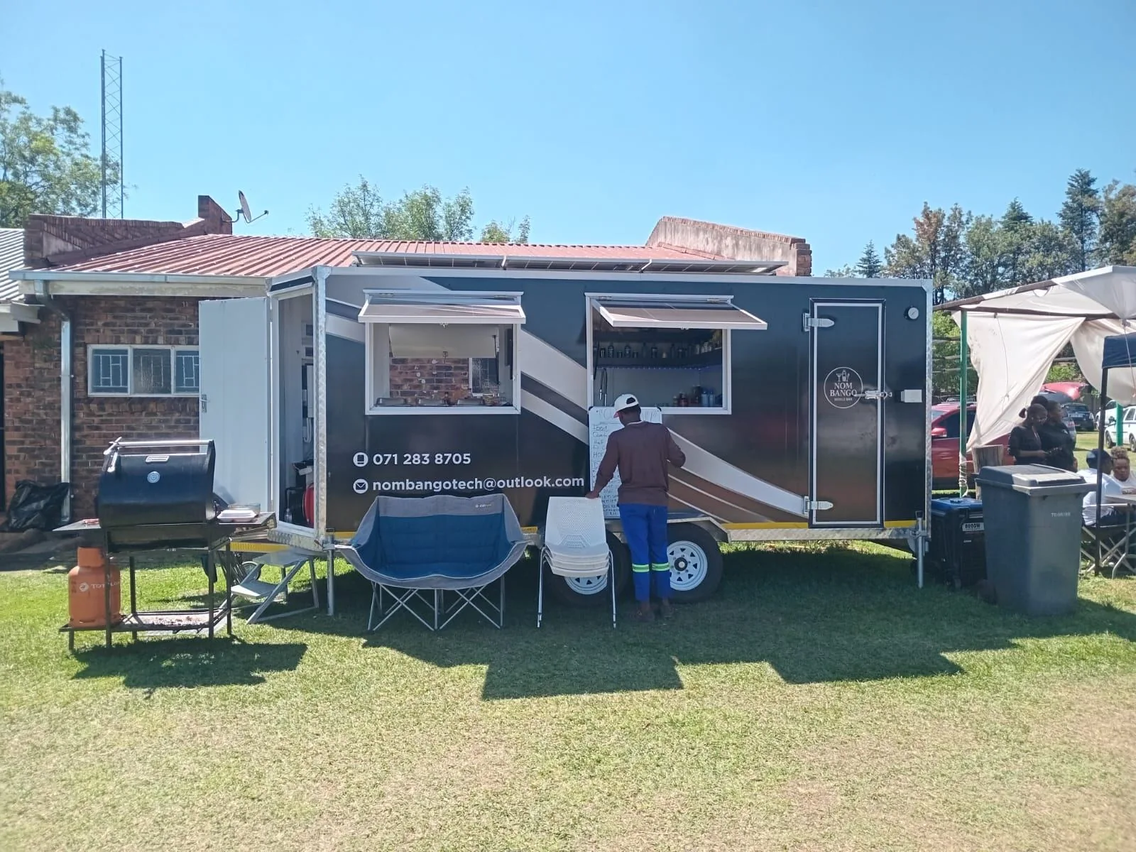 Nom Bango mobile bar set up on grass outdoors