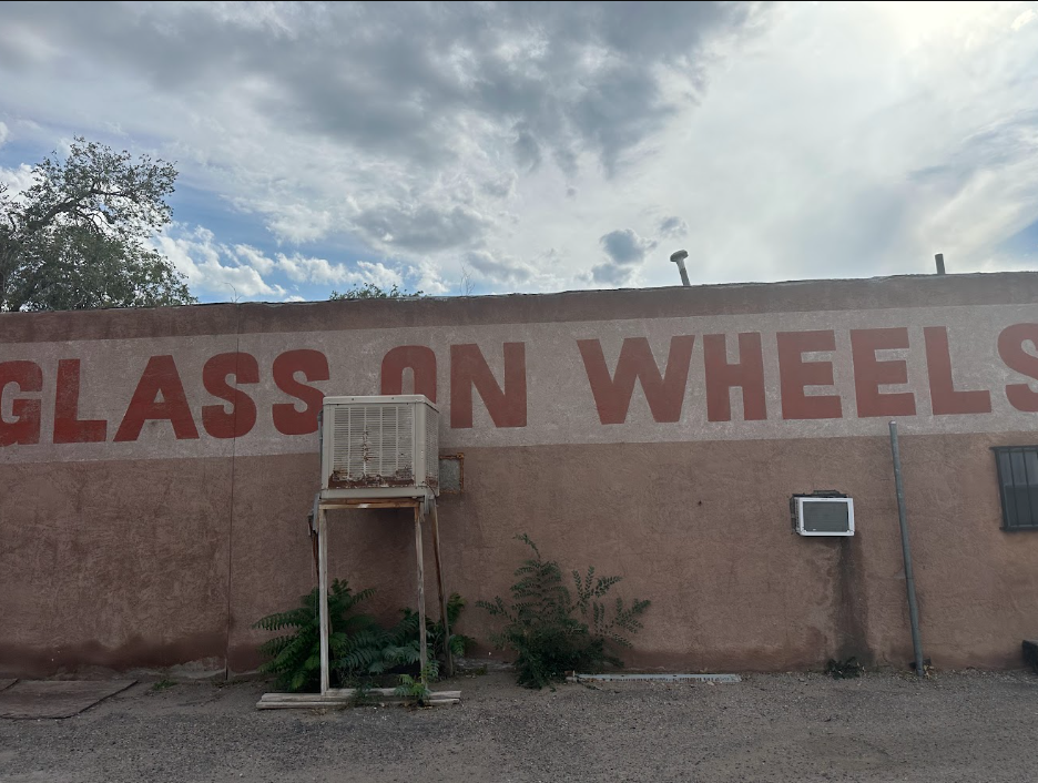 Historic Glass on Wheels hand-painted lettering on the adobe exterior shop wall in Albuquerque