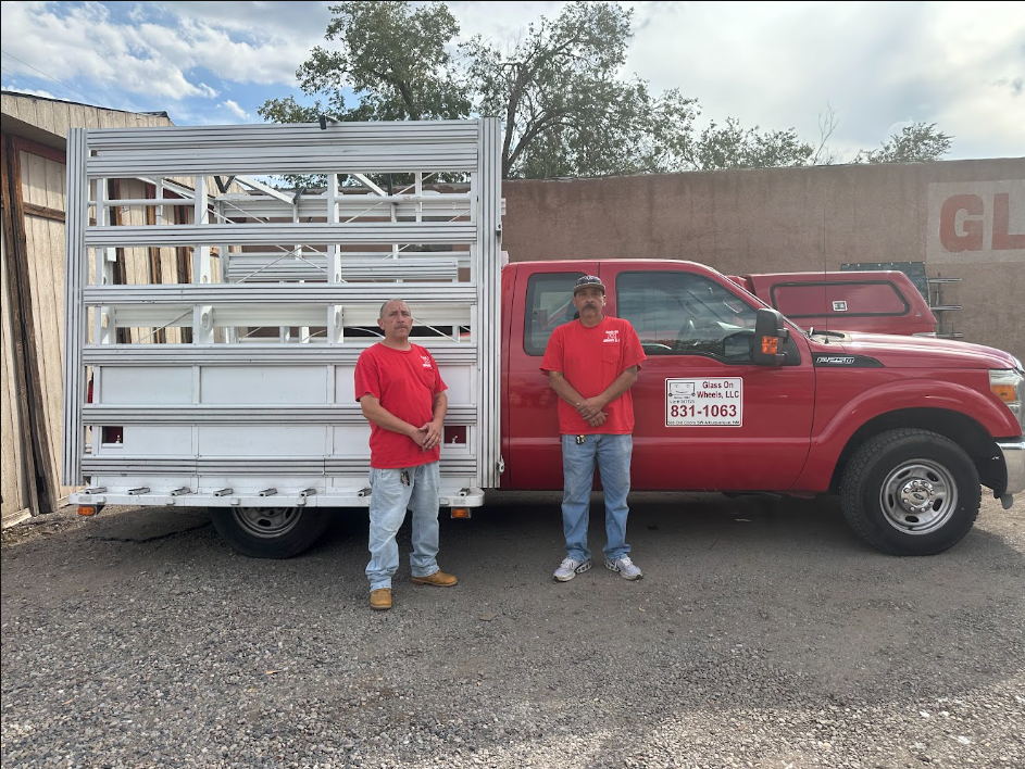 The Glass on Wheels crew beside our red Ford service truck equipped with glass rack