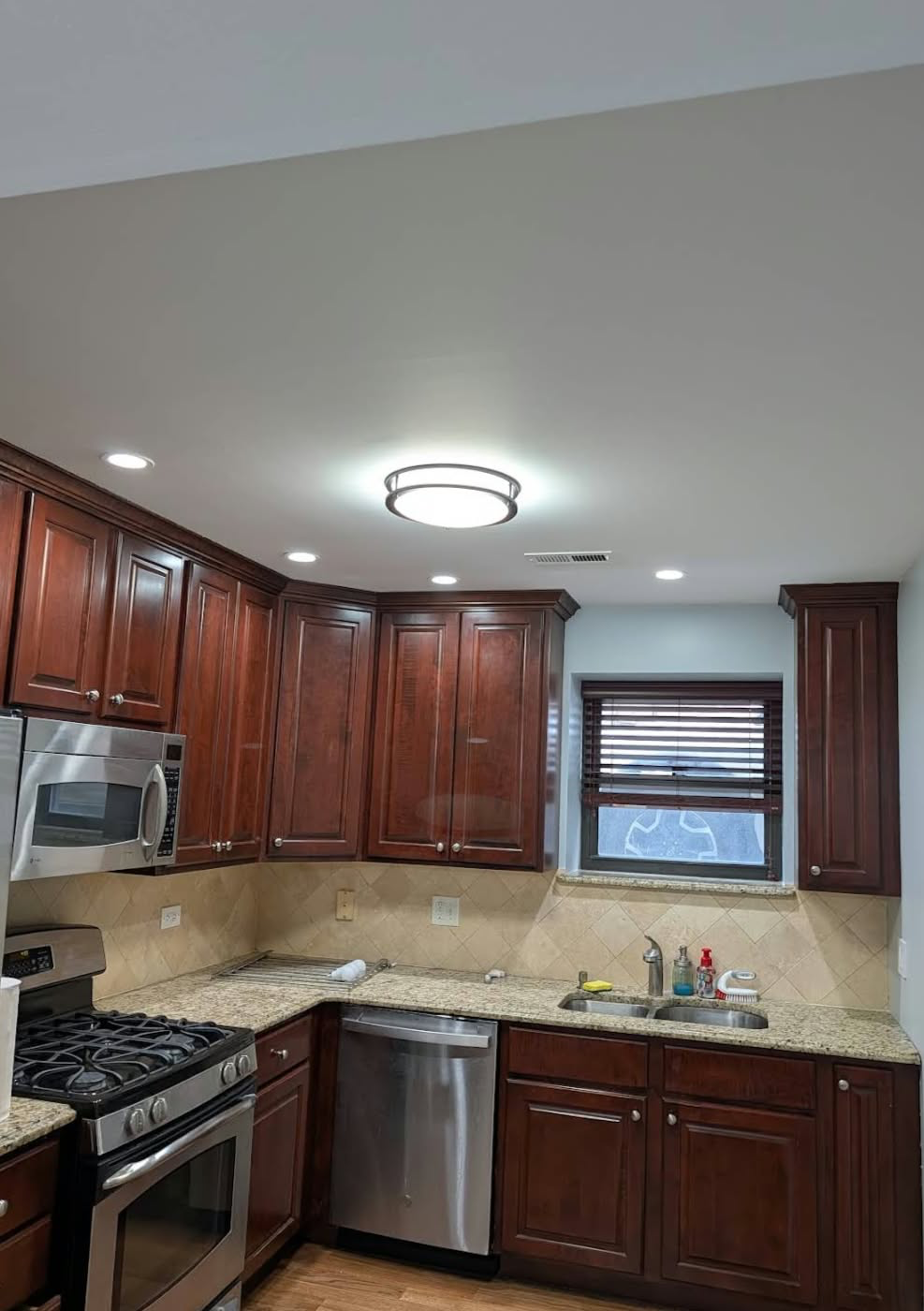 Remodeled cherry wood kitchen with granite countertops