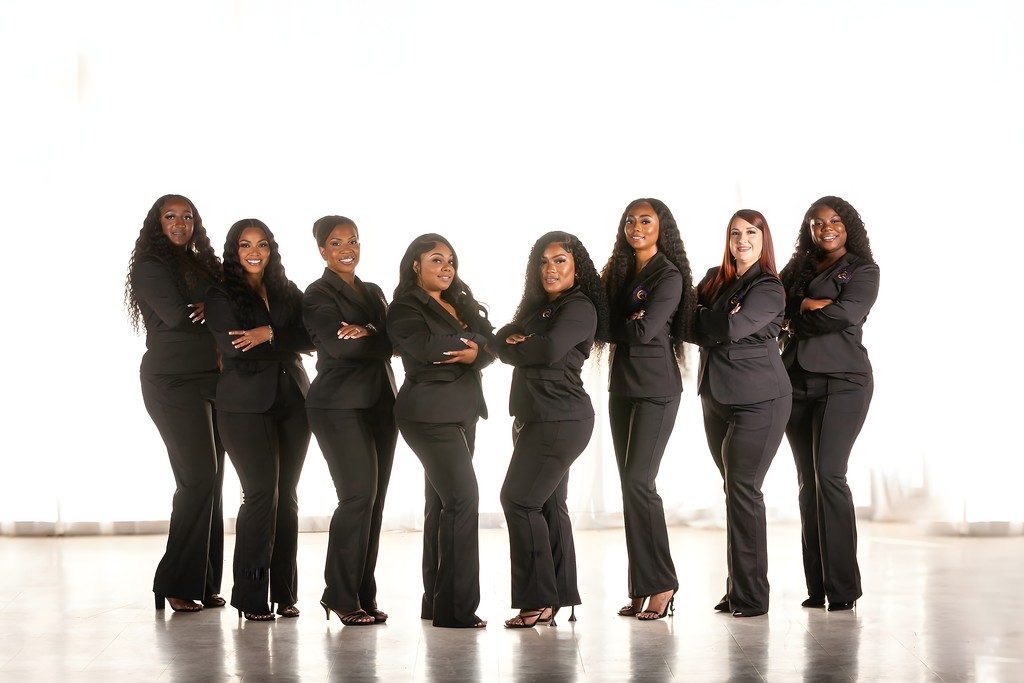 Qween Financial Services professional team standing in black formal suits