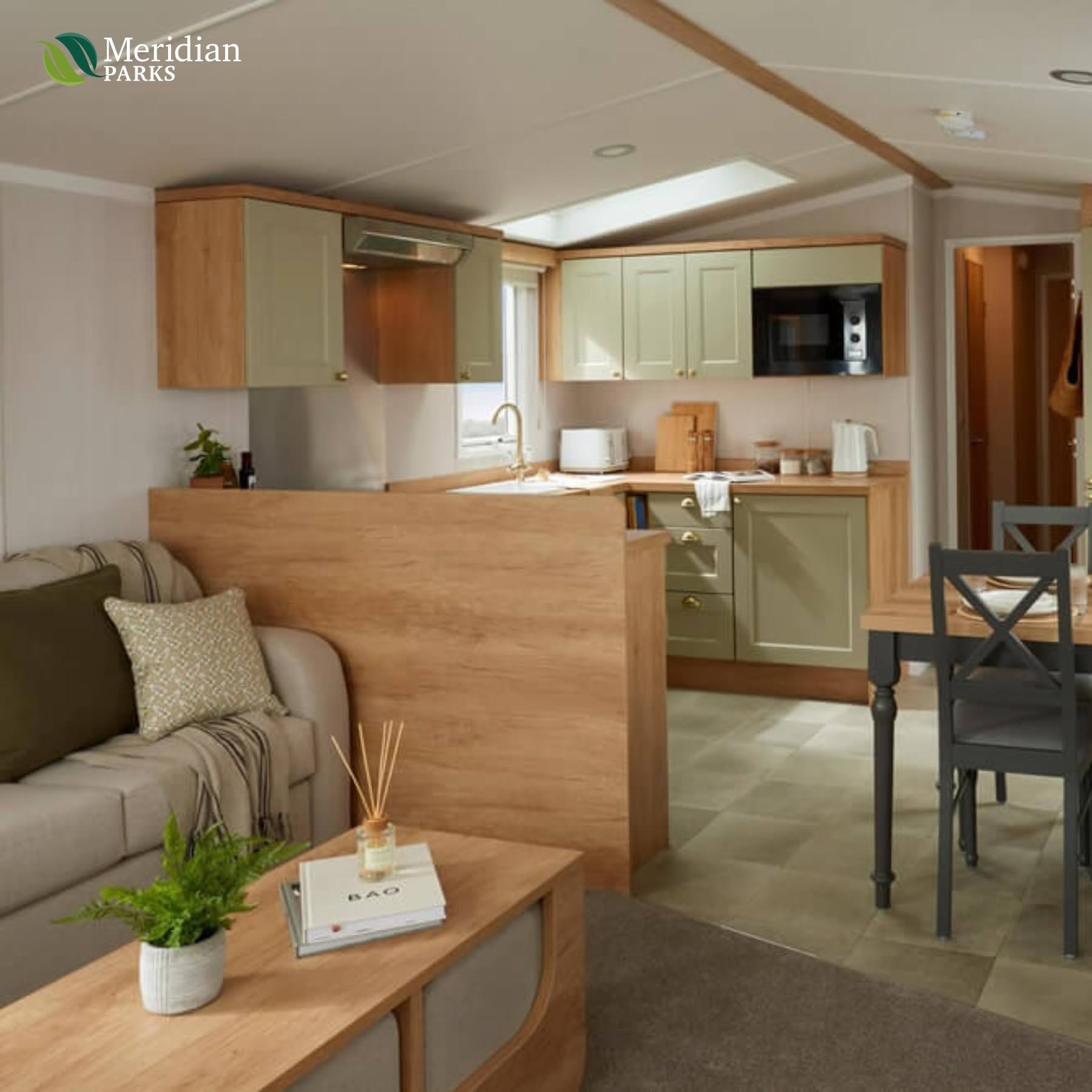 Contemporary fitted kitchen and cosy lounge area