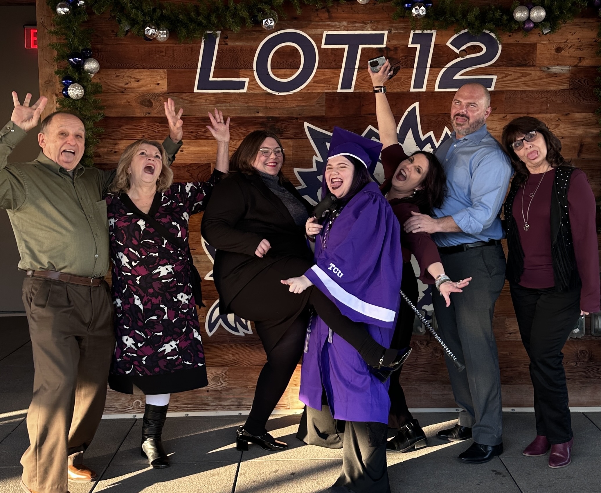 Rachel Harris family celebrating at TCU graduation under the Lot 12 sign