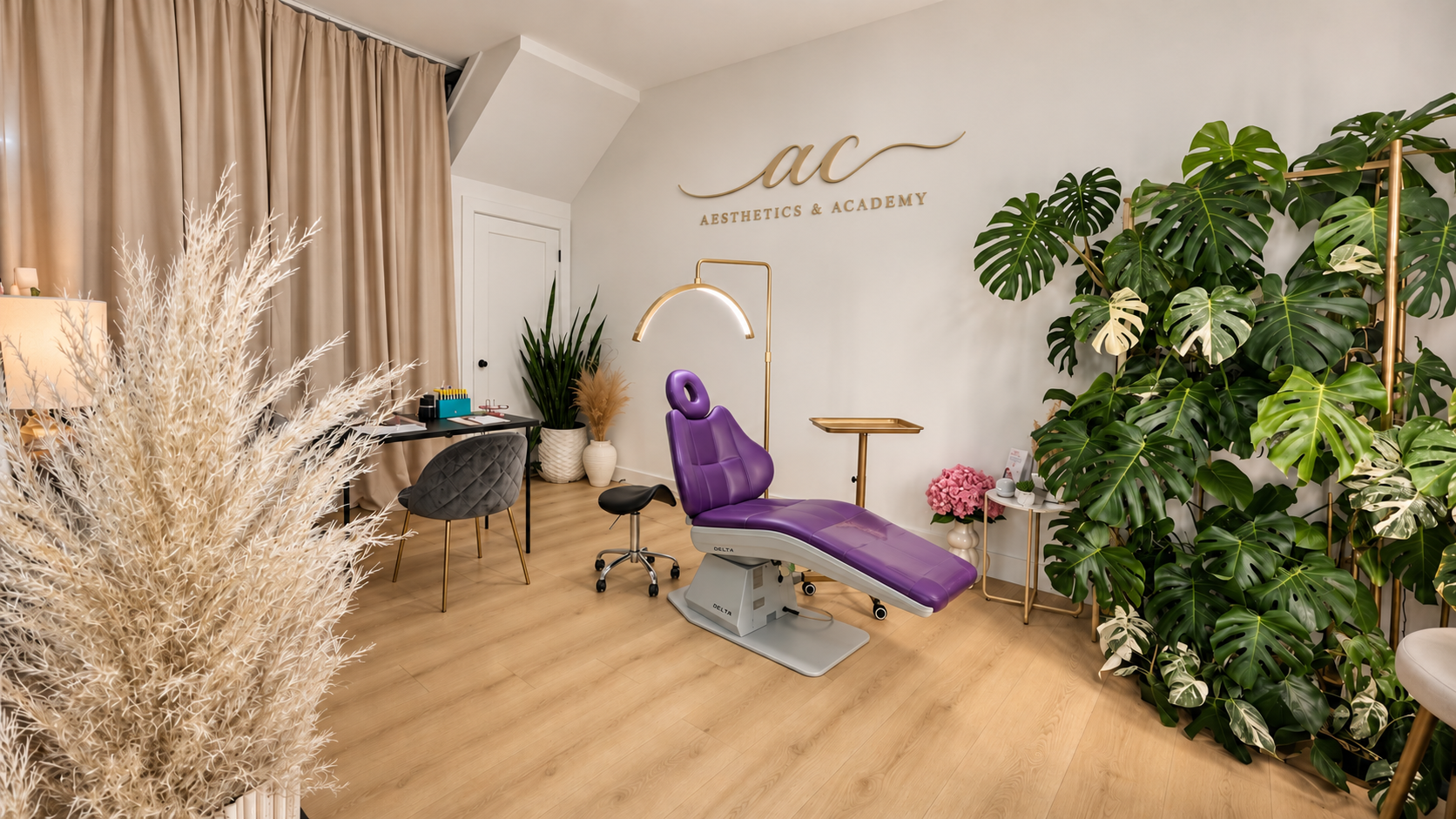 AC Aesthetics & Academy — private studio with master treatment bed, arched lighting, and lush greenery