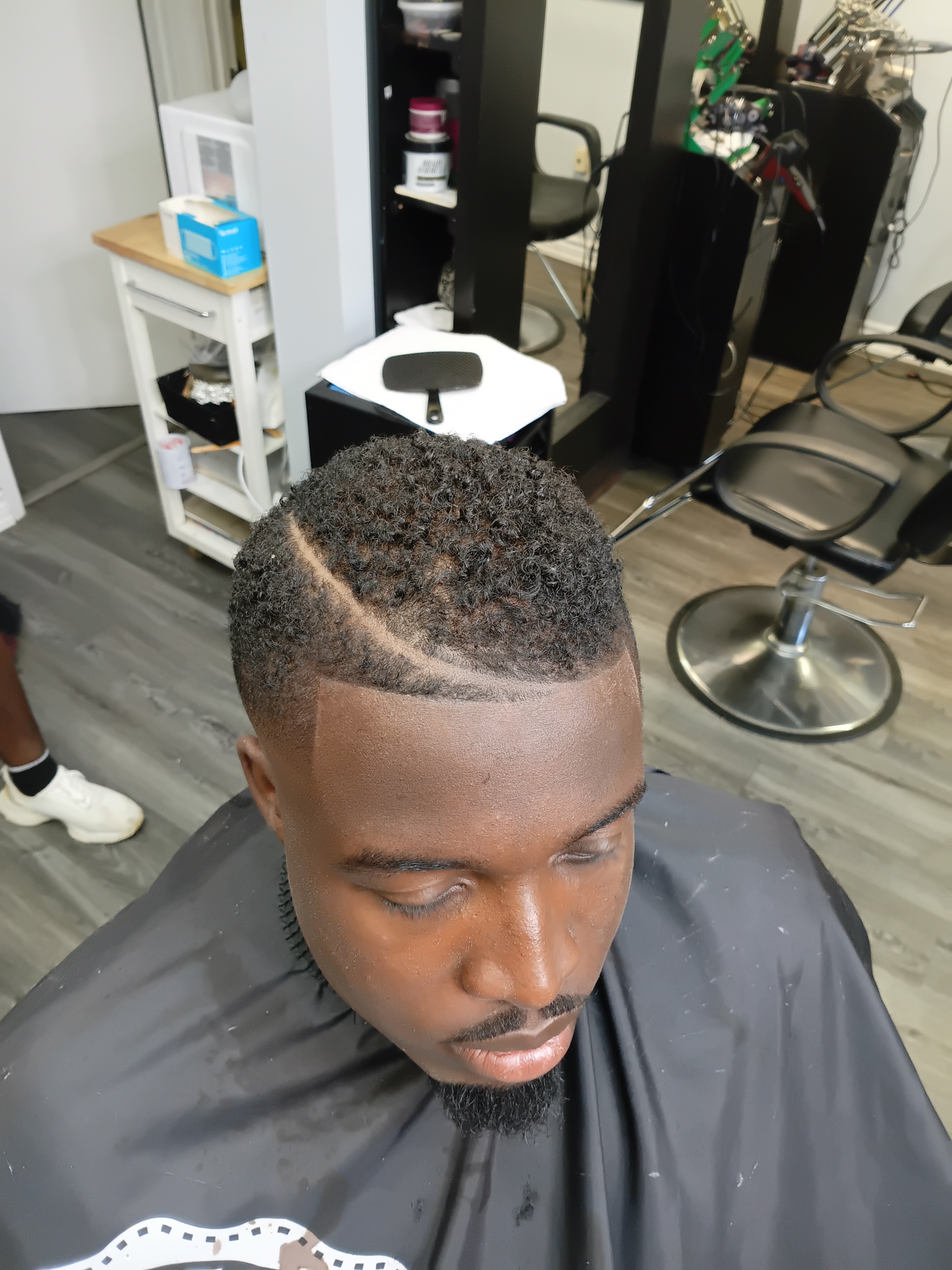 Textured twist curls with curved razor hard part and crisp temple taper at Image Barber Studio Scarborough