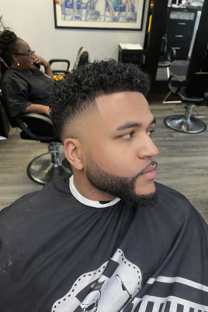 Seamless mid skin drop fade with textured curls and sharp defined beard contour at Image Barber Studio