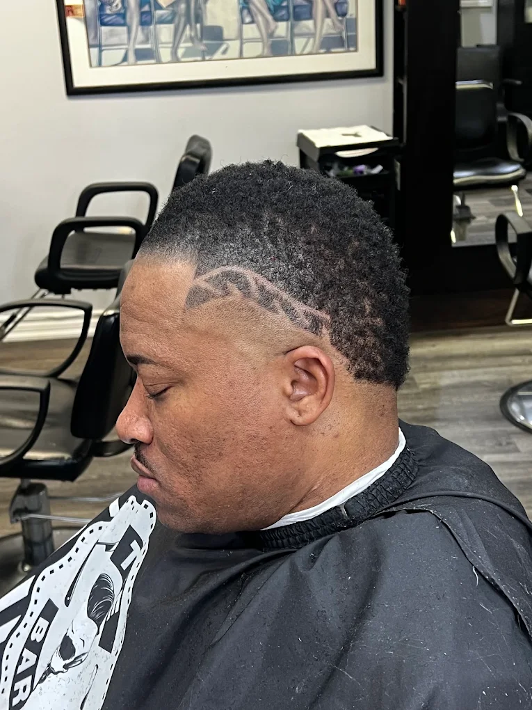 Precision temple taper with custom geometric wave razor carving on side profile at Image Barber Studio