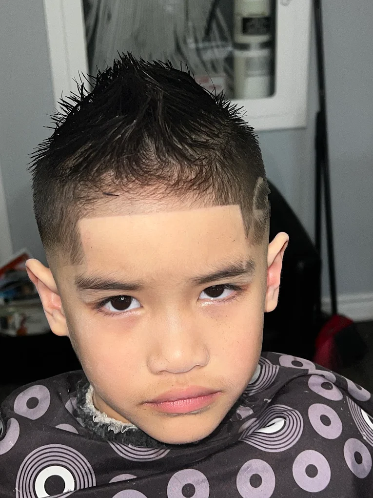 Young boy textured spiky crop haircut with razor-sharp geometric front box lineup and temple taper fade at Image Barber Studio Scarborough