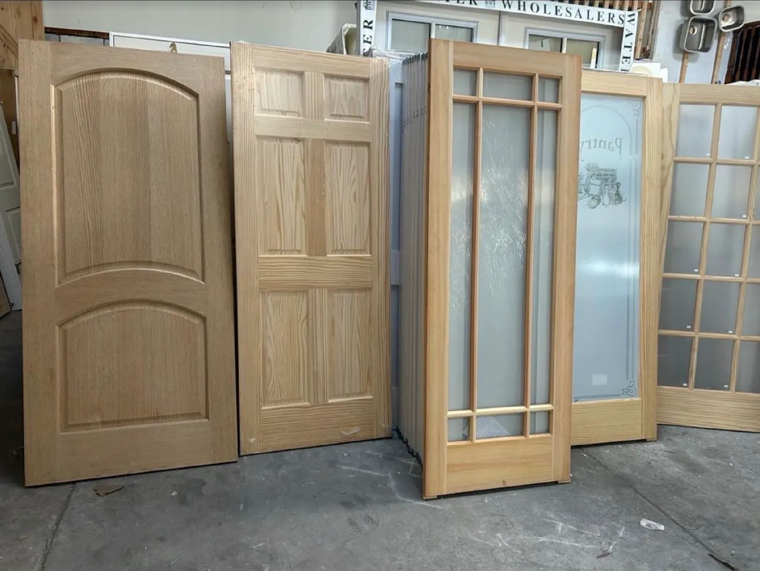 Natural wood interior and glass-paneled pantry doors in warehouse showroom
