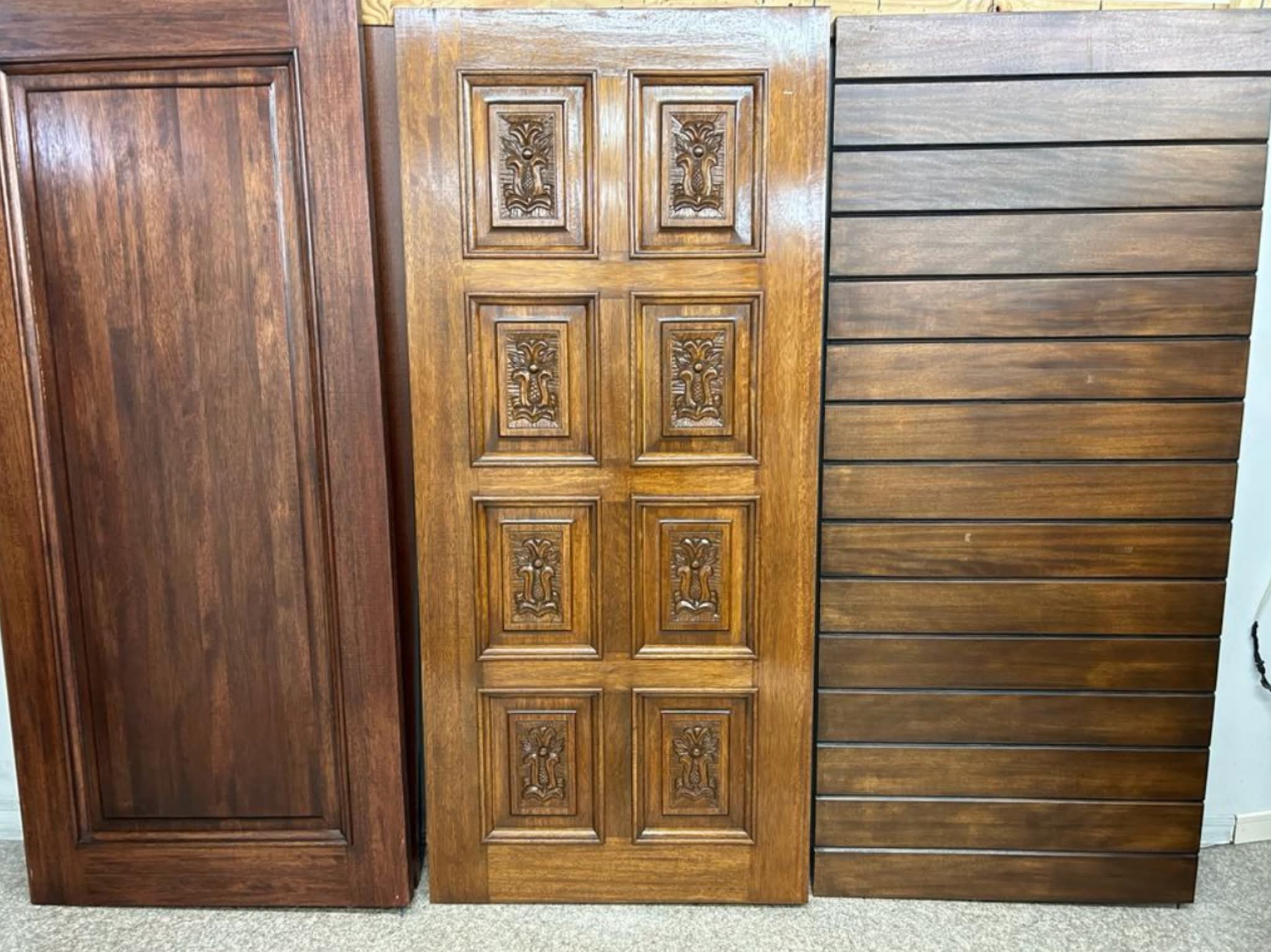 Carved decorative solid wood doors on display in showroom