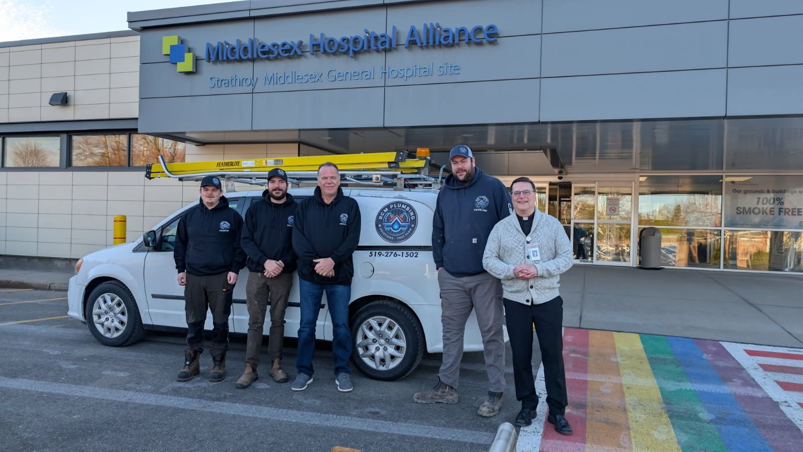 RCM Plumbing team and service van on location in Middlesex County