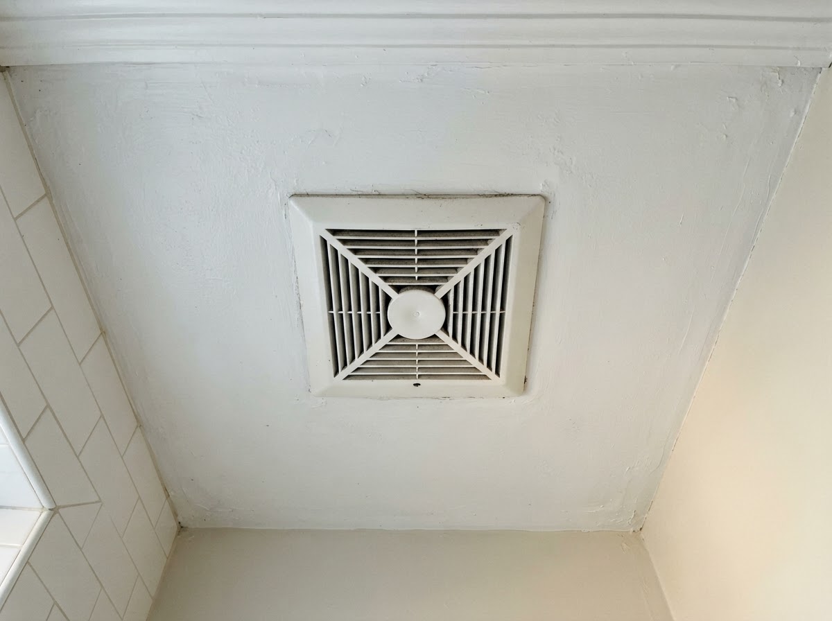 Bathroom exhaust ventilation fan grille on a ceiling