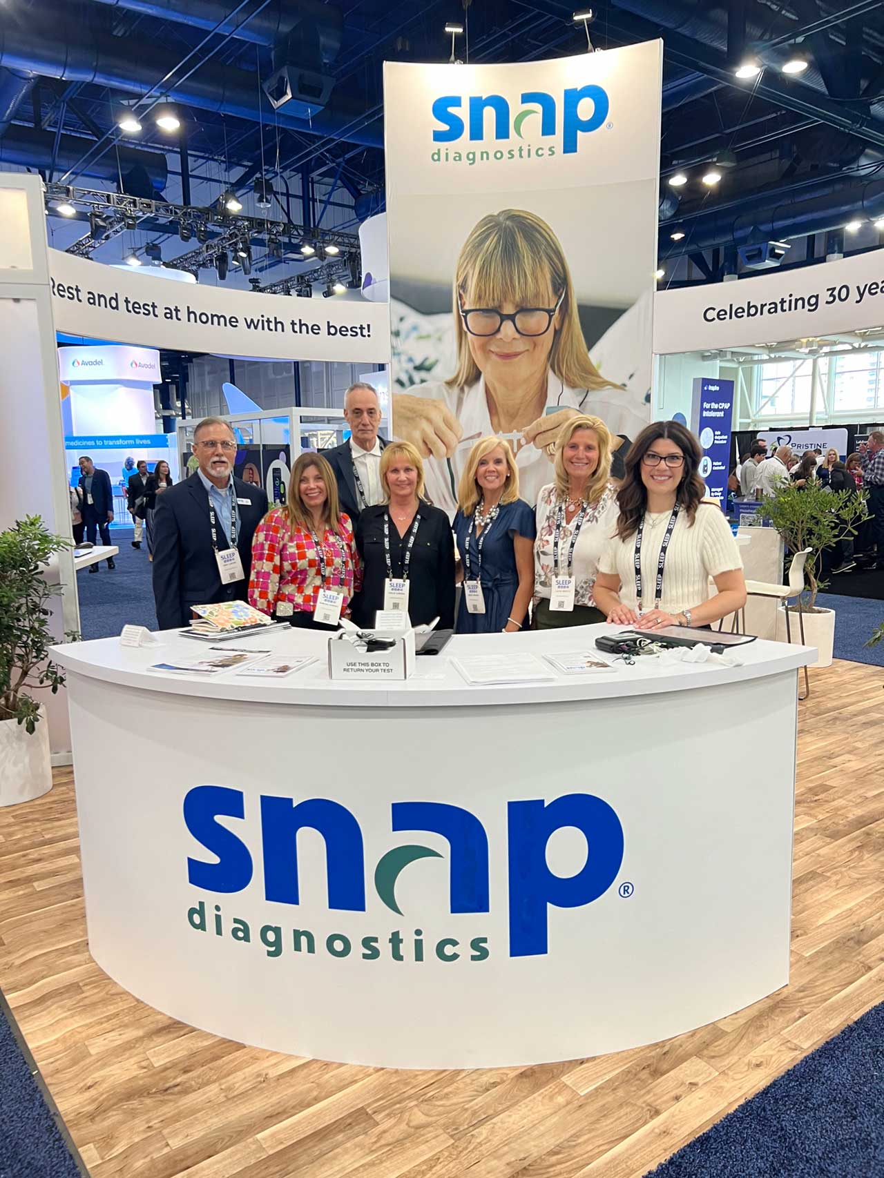 Snap team at their custom trade show booth crafted by Art & Display