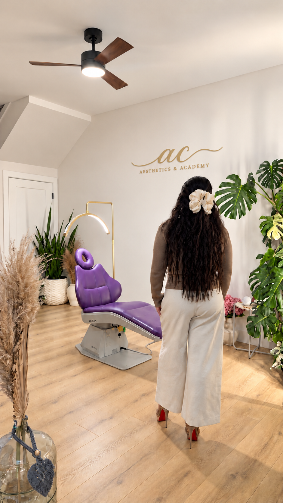 Educator inside the AC Aesthetics treatment suite with purple chair