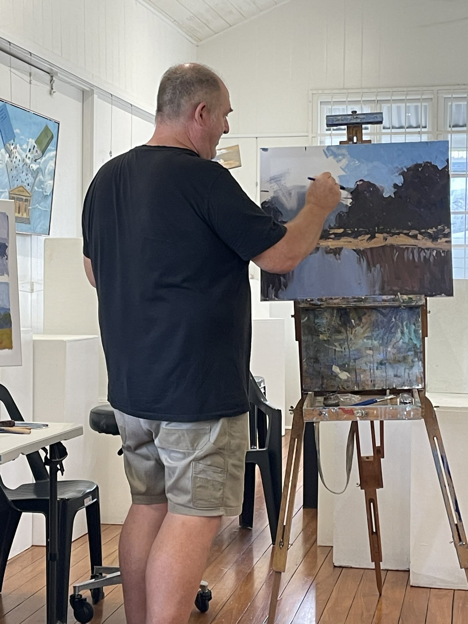 Rod Moore painting a landscape study at the easel in his studio