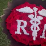 10 Rose Petals custom medical caduceus emblem handcrafted with white roses on red velvet backdrop